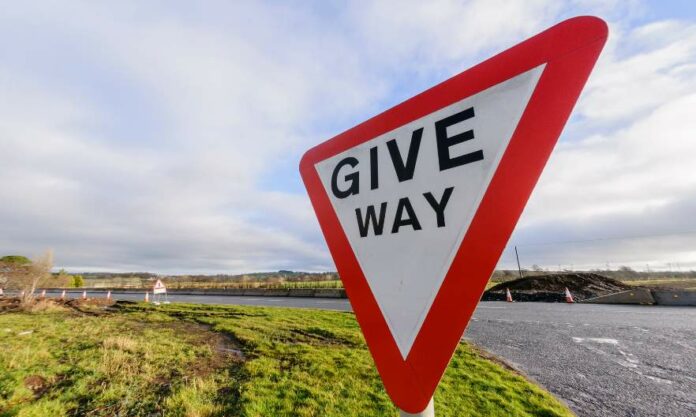 What does the give way sign mean